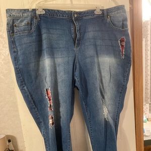 Woman within jeans distressed with Buffalo plaid
